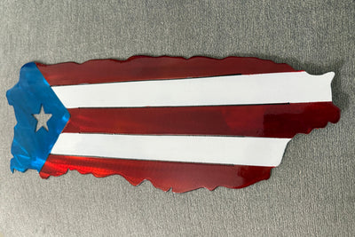 Metal wall art in the shape of a map of Puerto Rico with red, white, and blue colors