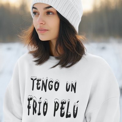 Woman wearing a white sweater with text and a white knit beanie with a red pom-pom in a snowy landscape.